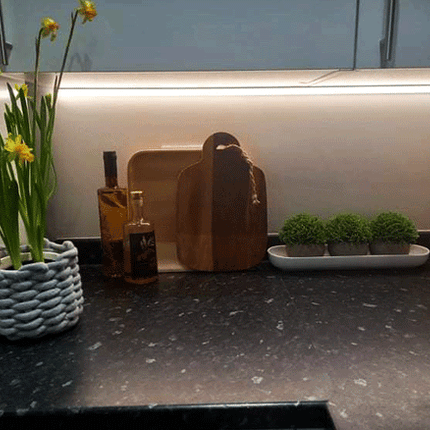 White illuminated kitchen cabinet underside using a RGBW seamless 24V LED tape light