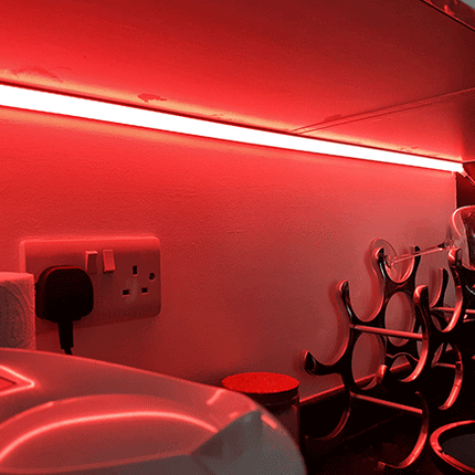 Salmon pink lit kitchen cabinet underside using RGBW seamless COB LED tape light. 24V.